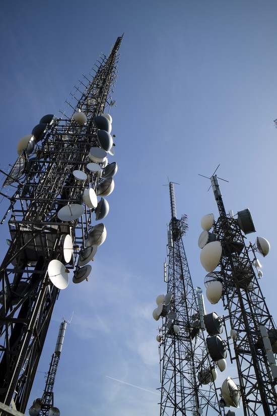 Cell towers against a clear blue sky