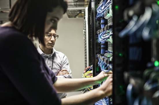 Technicians working on a server rack